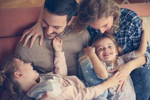 Laughing family on the couch