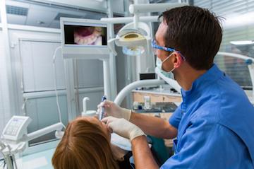 dentist using an intraoral camera on a patient