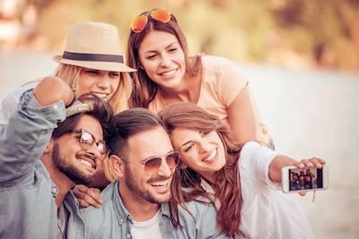 Group of friends smiling taking a selfie