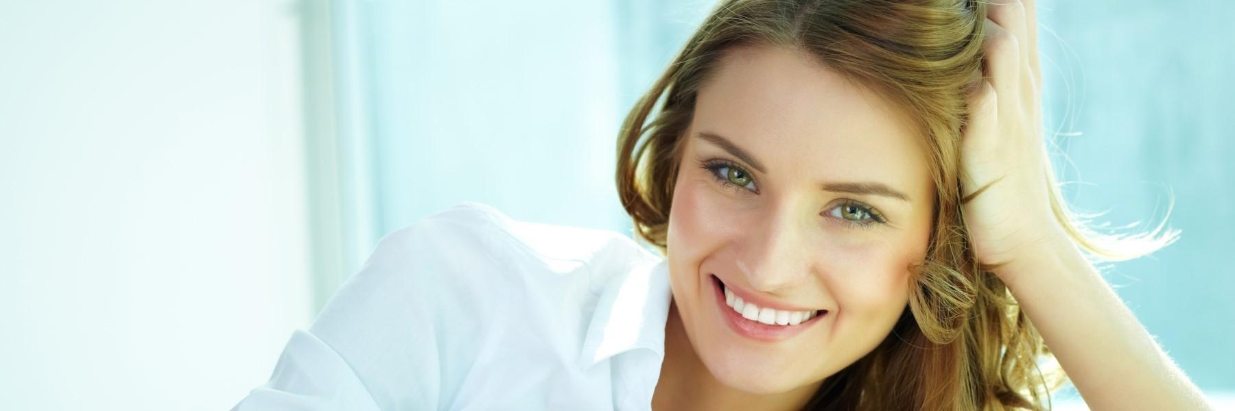 Woman smiling and leaning on her hand