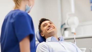 Man in Dental Chair with Hygienist | Dental Cleanings in Gaithersburg