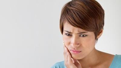 Woman holding jaw in pain | Gaithersburg Dentist