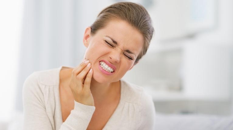 Woman holding jaw in pain | Emergency Dentist Gaithersburg MD