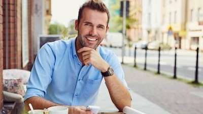 man smiling at a cafe | veneers in Gaithersburg, MD